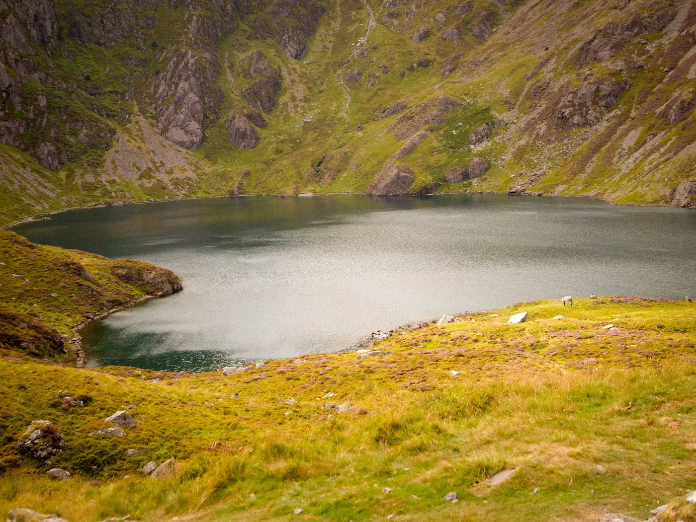 A dark mountain lake held in a glacial cwm
