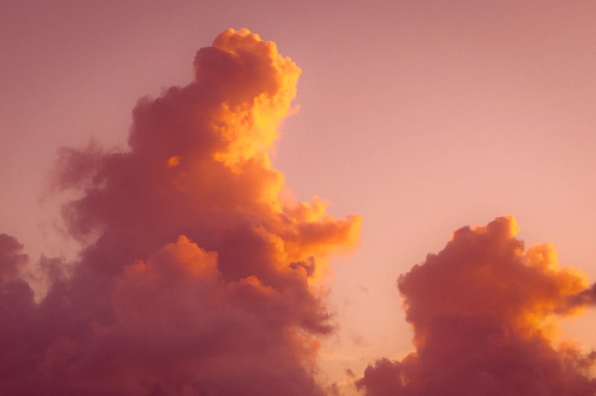 Storm clouds lit orange and pink at sunset
