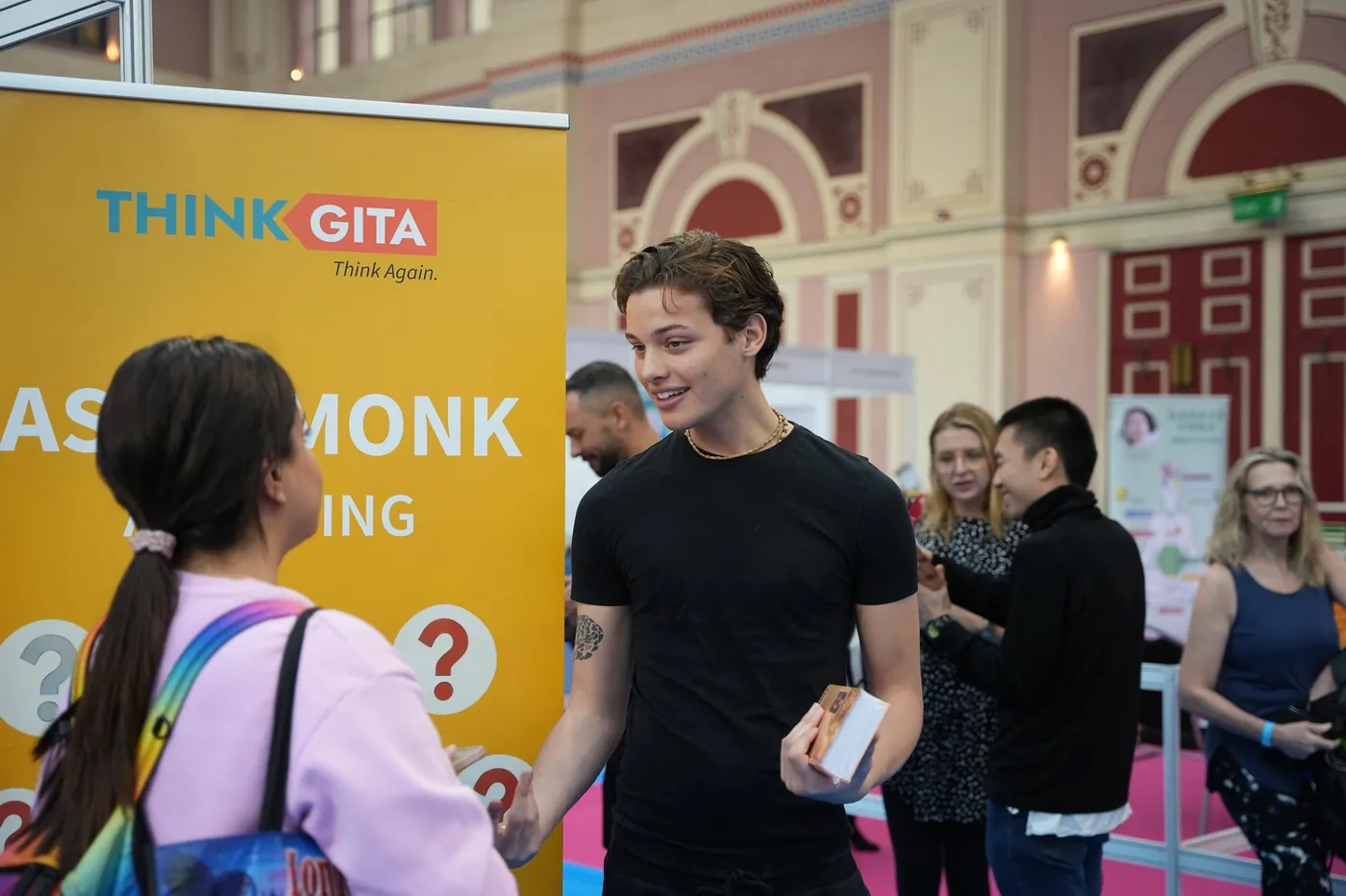 Charlie talking with a visitor at the Think Gita stand
